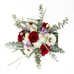 To a local Basildon florist, this bouquet exemplifies understated confidence and contemporary flair. Anchoring the design are crisp white gerberas with their bold coffee centers, standing out amidst rich, ruby-red roses that evoke the promise of affection and celebration. Wisps of fresh eucalyptus sway above, adding movement and brushing the arrangement with a cool, silvery haze-akin to morning mists along Mill Meadows. Punctuating the composition are lilac lisianthus, providing a dash of modern colour and visual intrigue-a nod to Basildon's evolving creative scene. Clusters of frothy white filler flowers create seamless transitions between each major bloom. Wrapping the base, broad, glossy leaves form a lush, sculptural ring, their depth reflected in water that bathes the exposed stems within the vase. Whether chosen to mark a milestone birthday in Vange or convey comfort in Lee Chapel, this full-bodied arrangement from Flower Delivery Basildon expresses heartfelt care and artistry-a testament to the area's reputation for warmth and innovation.